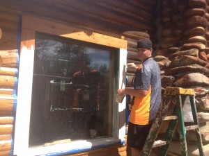 Alex painting some windows for future volunteers to enjoy. 